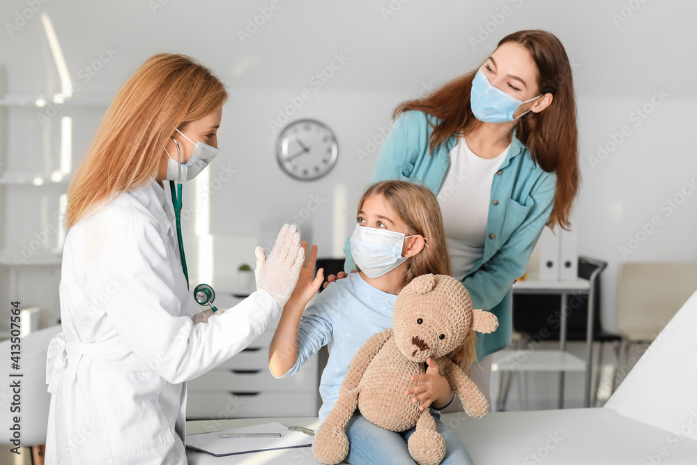Pediatrician examining little girl in clinic Pediatrician examining little girl in clinic