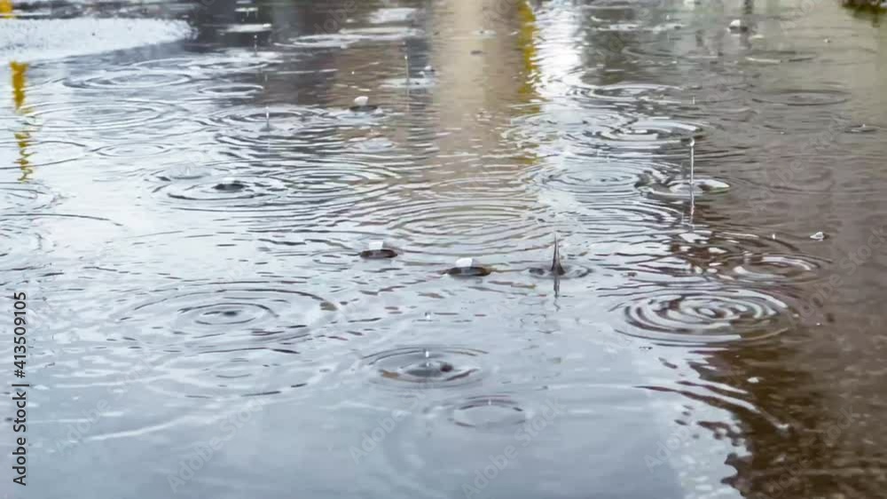 Rain drops falling in the big puddle making a big bubbles slow motion 4K footage. Rain drops falling in the big puddle making a big bubbles slow motion 4K footage.