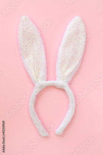 Fluffy bunny ears isolated on pink background, top view, flat lay.