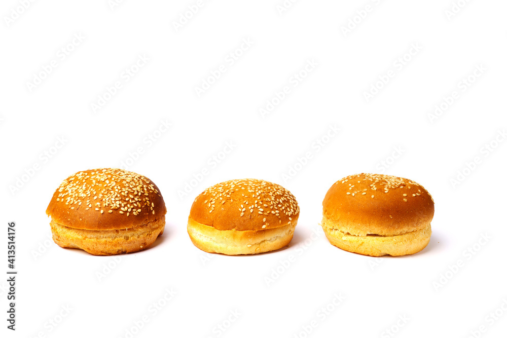 Three buns with sesame seeds isolated on a white