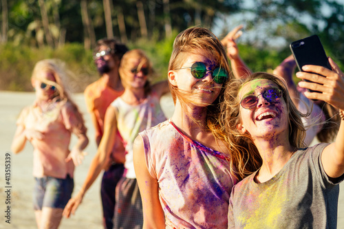 happy people taking self portraits on smartphone in India Goa fest