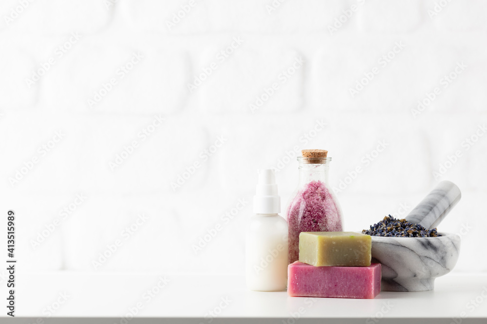 Cosmetics bottles and natural handmade soap on white background Cosmetics bottles and natural handmade soap on white background