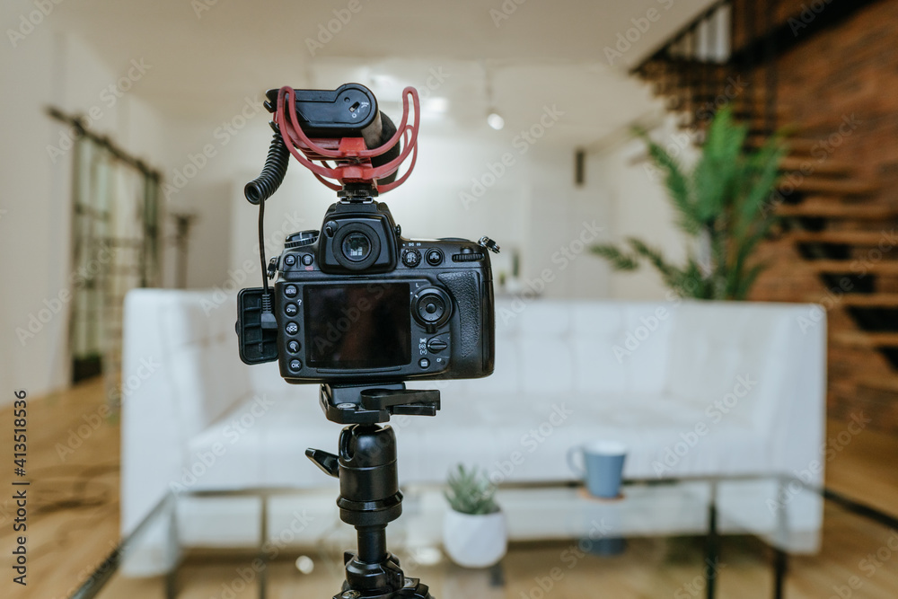 Camera with microphone on the tripod in the living room Camera with microphone on the tripod in the living room