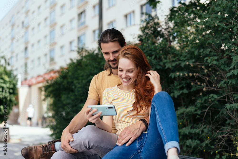 Young couple taking a break to relax in town