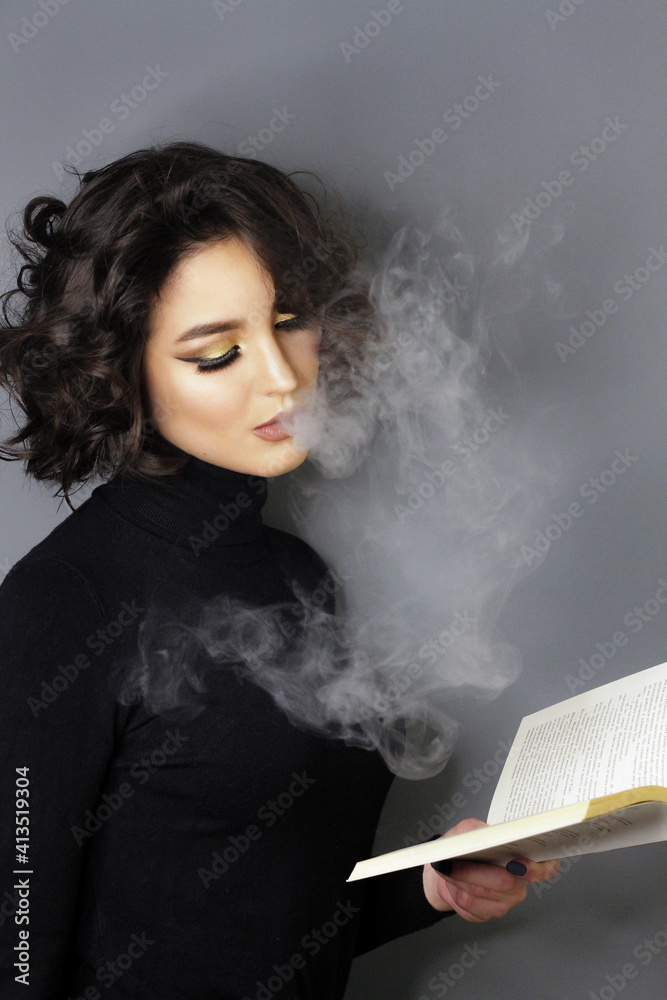 Beautiful young brunette model with bright make-up and curly hair