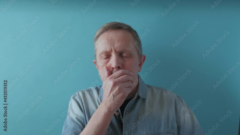 Senior man coughs and put on a medical mask. An elderly man putting medical mask on face. Protection from spreading coronavirus. 4k footage Senior man coughs and put on a medical mask. An elderly man putting medical mask on face. Protection from spreading coronavirus. 4k footage