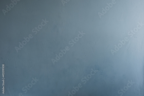 Just a plastered wall, textured, with scratches, pits, cracks, painted in light blue.