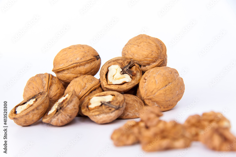 Walnuts in a shell on a white background. Healthy nuts.
