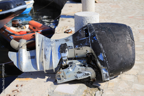 Old broken boat engine on the pier