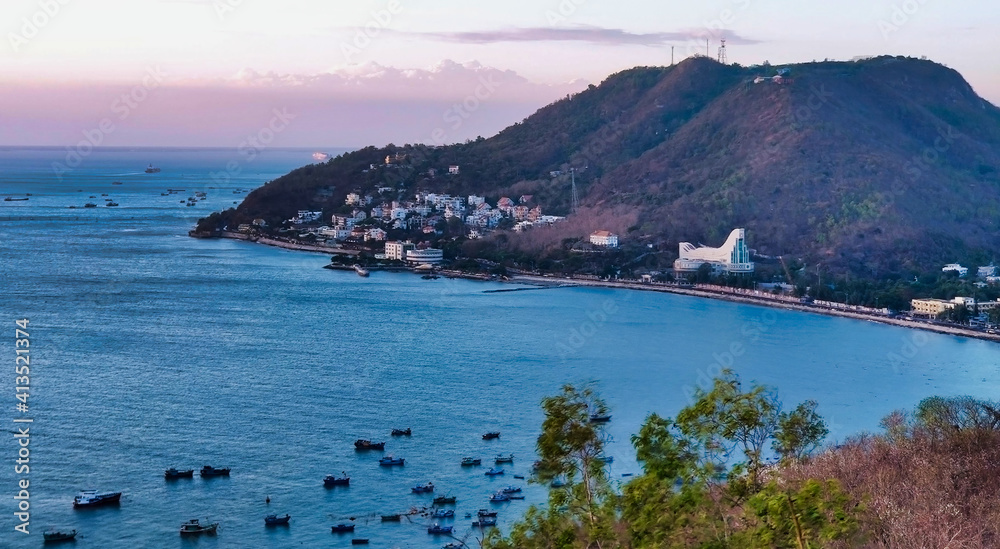 View of Front Beach. Coastline of Vung Tau. Sea, palm trees and hill. Vietnam. South-East Asia	