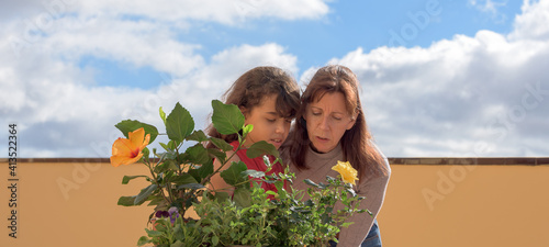 mother and daugther sharing emotions with new plants photo