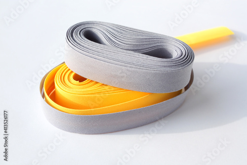 Yellow and gray oblique ribbons on a white background