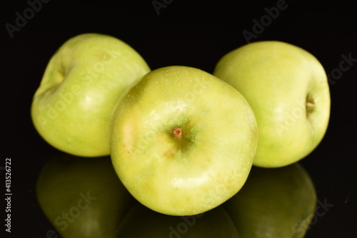 Three organic green apples by Renet Simirenko, close-up, isolated on black. photo