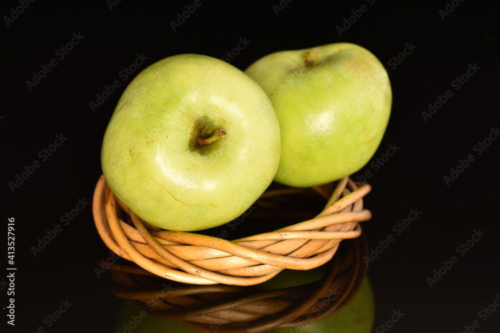 Two natural green apples by Renet Simirenko with a vine wreath, close-up, isolated on black. Two natural green apples by Renet Simirenko with a vine wreath, close-up, isolated on black.