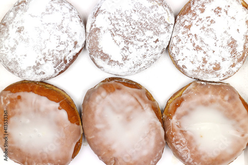 Six Paczki in a box overhead, Paczski is deep fried dough shaped into spheres, often filled with sweet filling, glazed with frosting or powdered sugar. A Fat Tuesday Mardi Gras tradition.  photo