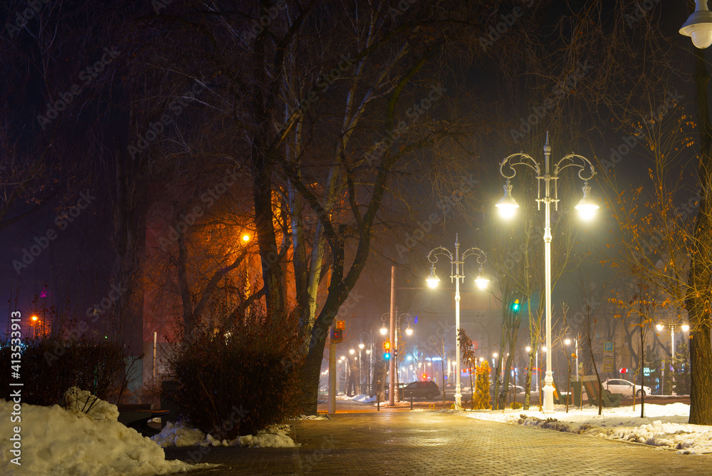 Almaty city streets view on a foggy winter night