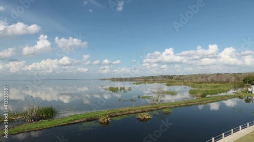 Brilliant blue sky and clouds reflect on Lake Apopka at Winter Garden Florida
