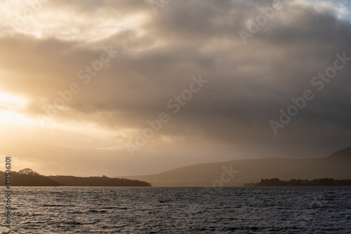 Stunning landscape image of Milarrochy Bay on Loch Lomond in Scottish Highlands with stunning Winter evening ligh