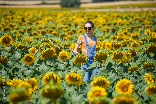 Girl in the middle of field with sunflowers