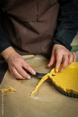 Female baker prepares vegetable pie 