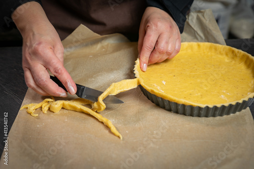 Female baker prepares vegetable pie 