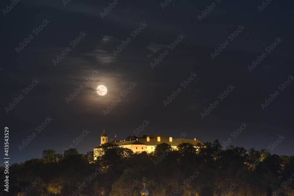 Moonrise over Spilberk castle in the cloudy night. Brno, South Moravia, Czech republic, Europe.