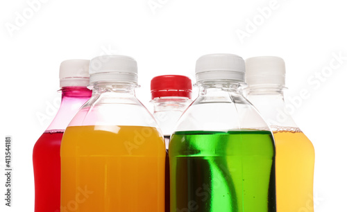 Bottles of soft drinks on white background, closeup
