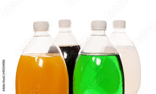 Bottles of soft drinks on white background, closeup