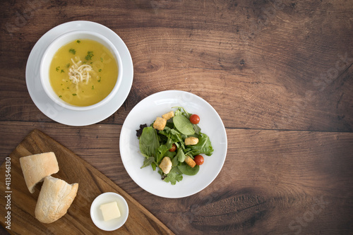 Chicken Noodle Soup and Salad on a Wooden Table