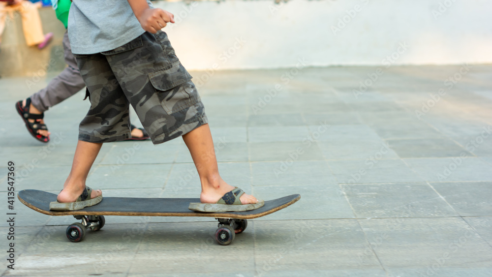 young skateboarder foot in action on a skateboard young skateboarder foot in action on a skateboard