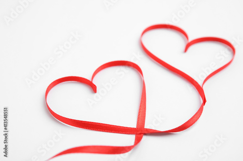 Hearts made of red ribbon on white background. Valentine's day celebration