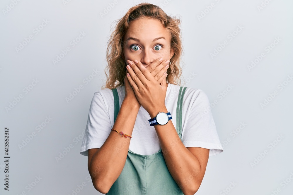 Beautiful caucasian woman wearing casual clothes shocked covering mouth with hands for mistake. secret concept. Beautiful caucasian woman wearing casual clothes shocked covering mouth with hands for mistake. secret concept.