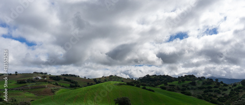 hills and farmland with fields and forests in the green and fertile Andalusian backcountry