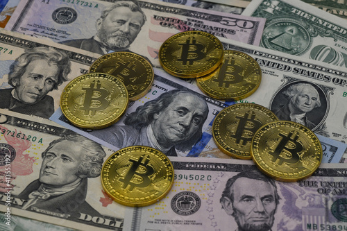 symbolic coins of bitcoin on banknotes of dollars