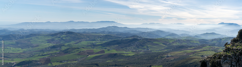 panorama landscape of rolling hills and blue mountain chains