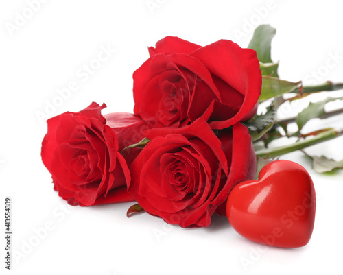 Beautiful red roses and heart on white background. St. Valentine's day celebration
