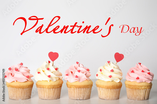 Tasty sweet cupcakes on white table. Happy Valentine s Day