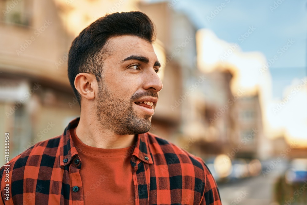 Young hispanic man smiling happy standing at the city. Young hispanic man smiling happy standing at the city.