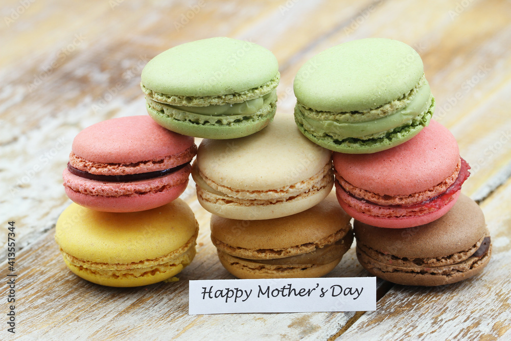 Happy Mothers day card with stack of colorful macaroon biscuits on rustic wooden surface