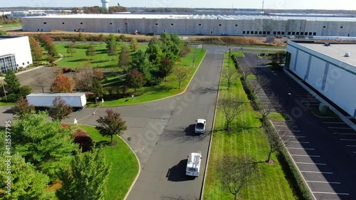 Birds Eye Shot of Business Vans Driving Down a Street