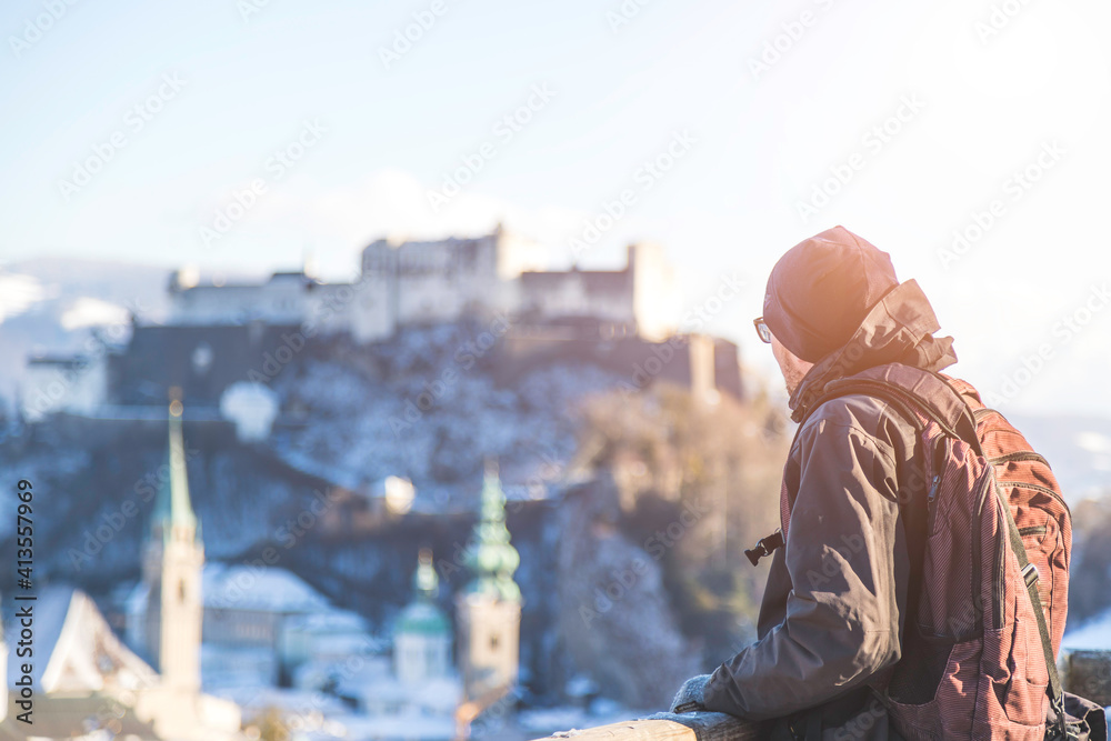 Enjoying the view over Salzburg: Young tourist man on the viewing platform