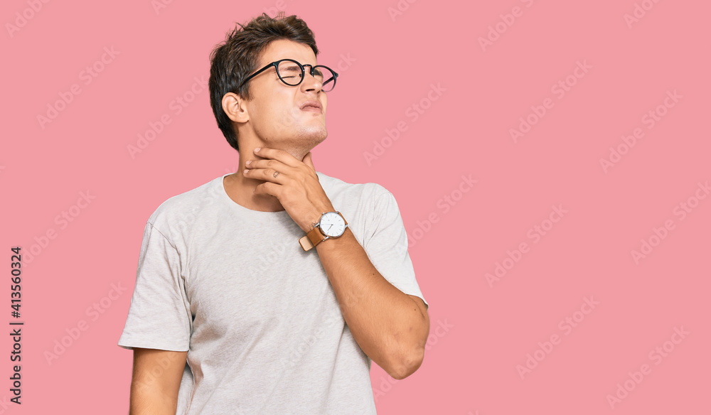 Handsome caucasian man wearing casual clothes and glasses touching painful neck, sore throat for flu, clod and infection Handsome caucasian man wearing casual clothes and glasses touching painful neck, sore throat for flu, clod and infection