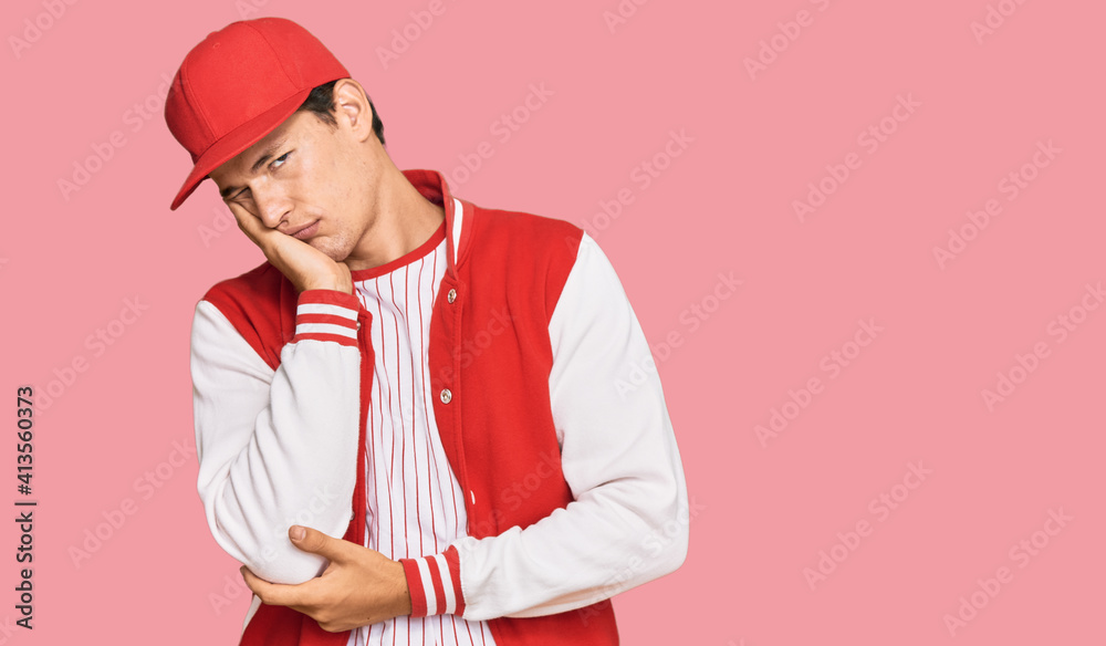 Handsome caucasian man wearing baseball uniform thinking looking tired and bored with depression problems with crossed arms. Handsome caucasian man wearing baseball uniform thinking looking tired and bored with depression problems with crossed arms.