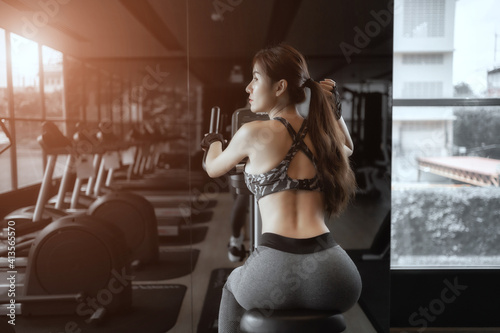 Soft focus consept women are exercising in gym fitness. Beautiful women in good shape from taking care of their bodies. Health concept. 