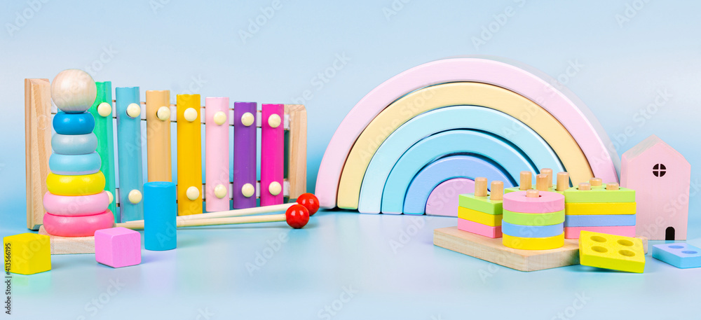 Kids toys collection. Wooden rainbow, educational and music baby toys on  light blue background Stock Photo | Adobe Stock