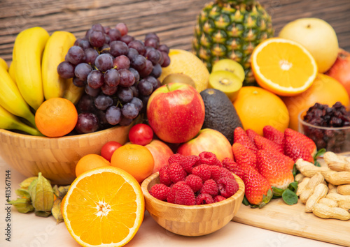 Group Fruits mixed with banana  orange  strawberry and nuts  concept health food and diet  vegetarian food in the top view on the wood table.