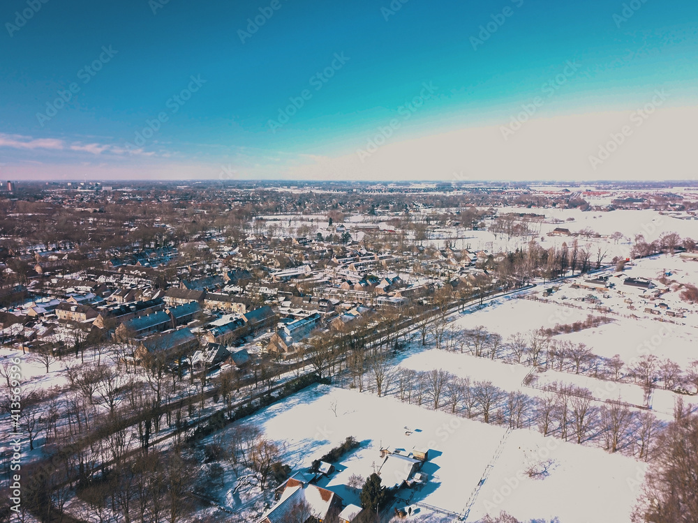 Aerial drone shot of the snowy landscape of the Netherlands.