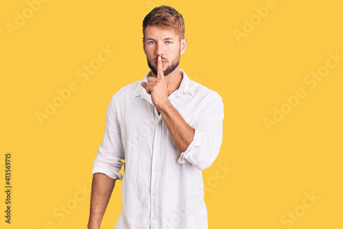 Young caucasian man wearing casual clothes asking to be quiet with finger on lips. silence and secret concept.