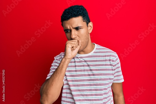 Young arab man wearing casual clothes feeling unwell and coughing as symptom for cold or bronchitis. health care concept.