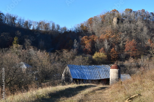 A homestead farm in the Driftless Area of Southwest Wisconsin, shown in the fall with oak trees and an old tobacco barn.